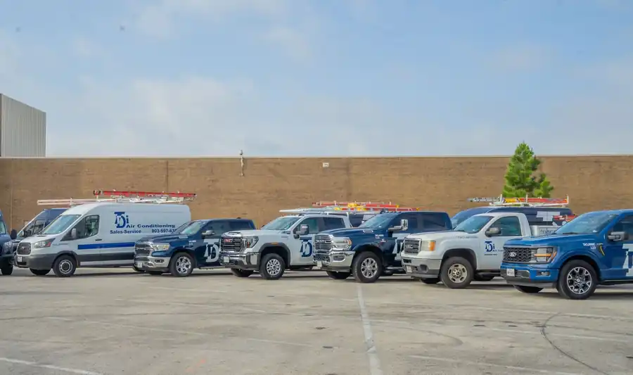 TDi Services trucks and vans parked in a row in front of the shop