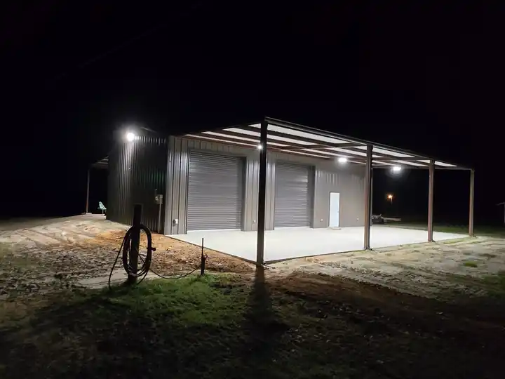 Metal shop and barn at night under lighting installed by the TDi electrical division