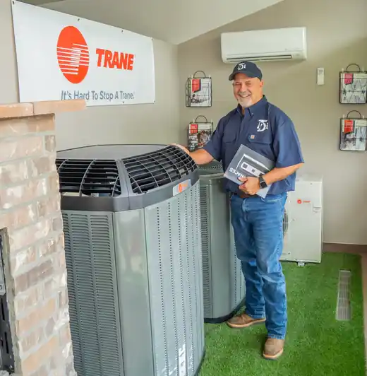TDi staff member beside a Trane condenser in the showroom booth